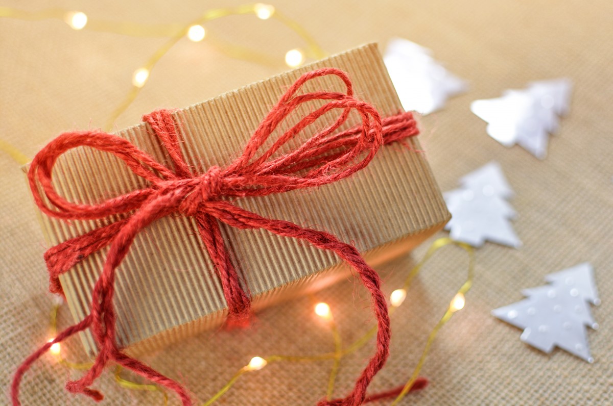 Gift box with a red bow and string lights - Photo credit: CC via pxhere.com